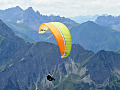paraglider in the sky near a mountainous range