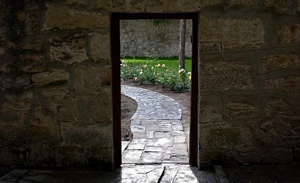 an door opening onto a pastoral scene